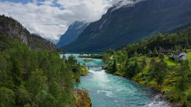 Lake bottom Loenvatnet with glacial river starting to flow dowm Lodalen valley - moving aerial