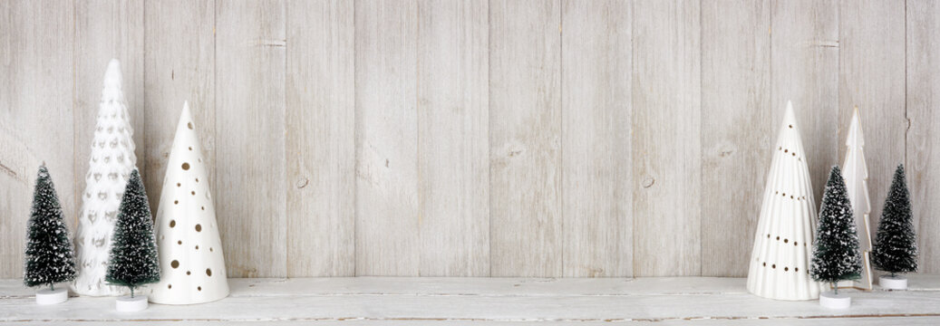 Modern Christmas tree decor on a shelf against a rustic grey wall banner background with copy space