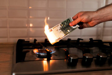 100 euro banknote on a gas burner. The concept of cost for natural gas. Energy crisis. High cost, gas price. Sanctions