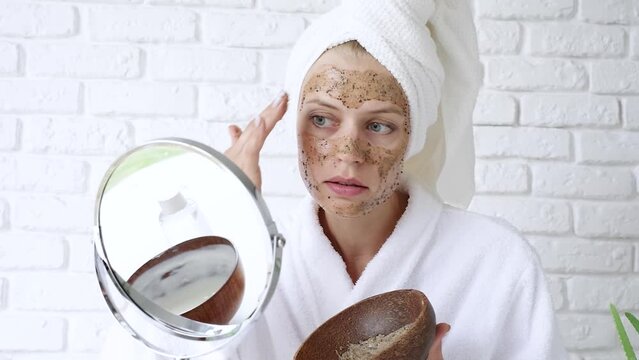 Beauty Face Care. Portrait Of Attractive Young Woman Putting Coffee Scrub On Facial Skin.woman applying face scrub