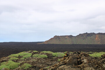 vulcanic landscape with vulcanos and craters on lanzarote, canary islands, spain