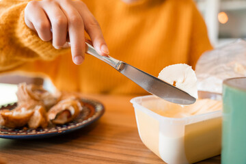 Cropped view of the focused girl preparing sandwiches for the breakfast