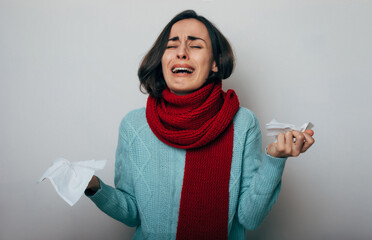 Young woman with a high temperature, wrapped scarf coughing. Sick female with flu and headache. Rhinitis, cold, sickness, allergy concept. Fit of coughing. Coronavirus epidemic