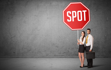 Fototapeta premium Young business person holding road sign