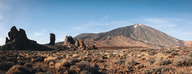 Foto op Canvas Panorama of caldera in Teide National Park, Tenerife, Canary Islands, Spain. Roques de Garcia in the foreground and snow covered mount Pico del Teide in the background. © Andrii Marushchynets