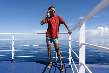 Older man talking on phone on sailboat 