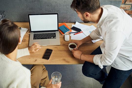 Closeup Of Two Business People Looking At Empty Blank Laptop Screen