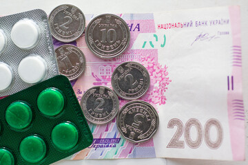 Ukrainian money with kopecks and medicines close-up - obrazy, fototapety, plakaty