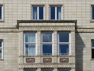 Streets of Berlin. Facade detail of Soviet Socialist architecture with ceramic decoration in Karl...