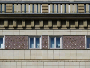 Streets of Berlin. Facade detail of Soviet Socialist architecture with ceramic decoration in Karl Marx Avenue (1952-1960). Germany.