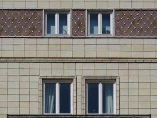 Streets of Berlin. Facade detail of Soviet Socialist architecture with ceramic decoration in Karl Marx Avenue (1952-1960). Germany.