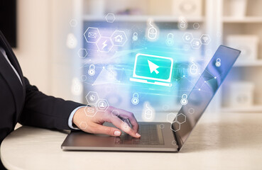 Hands working on laptop with digital icons