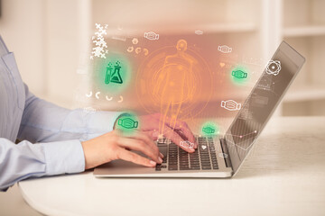 Doctor working on laptop with healthcare concept