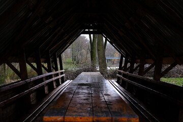 Panorama frame Eating area inside the pavilion of a park with view of trees and cloudy sky