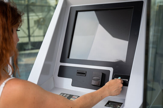 Caucasian woman buying tickets from the machine.
