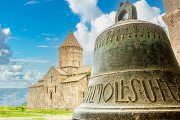 Church of Saints Paul and Peter with bell in foreground with ancient Armenian letters, Tatev...