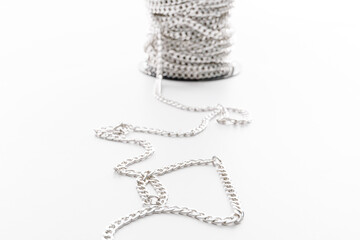 coil of decorative silver chain isolated on white background