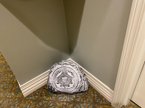 A United States Coast Guard Emblem On A Commemorative Plaster Rock.