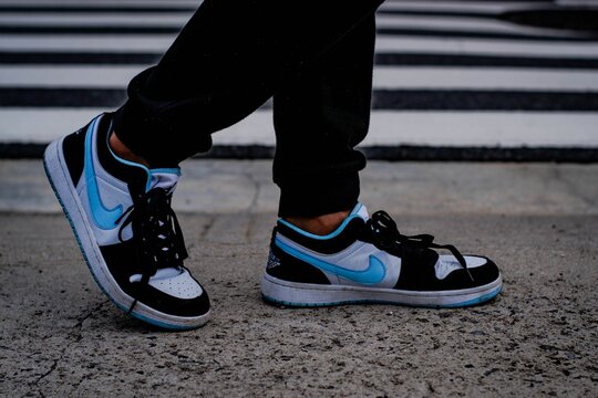 Closeup Shot Of Walking Feet Wearing Blue And Black Nike Dunks