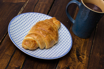 Fresh baked croissant with chocolate milk