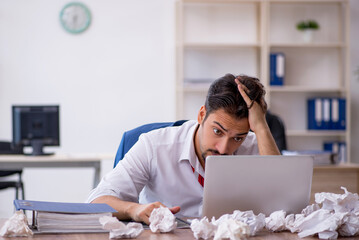 Young male employee in brainstorming concept