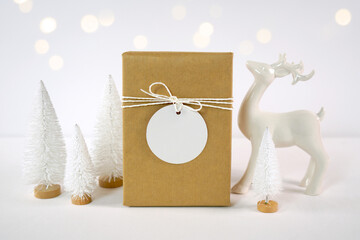 Christmas gift tag party favor thank you card mockup, styled with white reindeer and mini trees,...