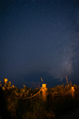 Sanibel, FL USA- 9-25-2022: Long-exposure shot in front of a walking path on the beach at night to reveal the milky way galaxy in the sky.