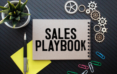 sales playbook on notepad with pen, glasses and calculator