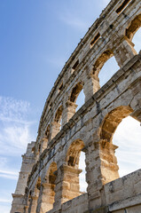 Ancient Roman arena wall. Detail of an arch on a beautiful sunny day.