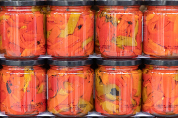 red peppers preserved in glass jar. food preservation concept