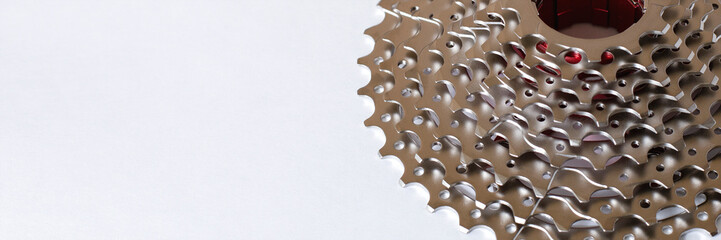 Banner with a rear cassette bike part in a mountain bike. Concept of the transport component on a light background