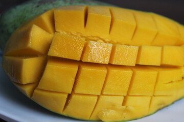 mango sliced ​​in squares on a plate
