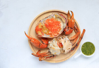 Steamed crab in a dish. Boiled crab fresh served with spicy sauce on white background. Thai food style,Top view. 