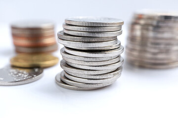 Money and Inflation Ideas. Stacks of silver coins on white background.