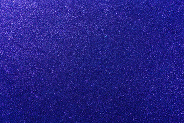 Background with sparkles. Backdrop with glitter. Shiny textured surface. Very dark blue