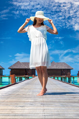 Woman standing on the wooden pier