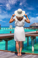 Woman standing on the wooden pier