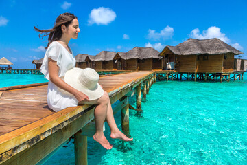 Woman sitting on the wooden pier