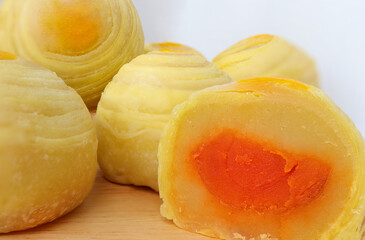 Chinese pastry or moon cake on wood plate. Chinese dessert Mini moon cake made from bean, flour and salted egg yolk.Top view