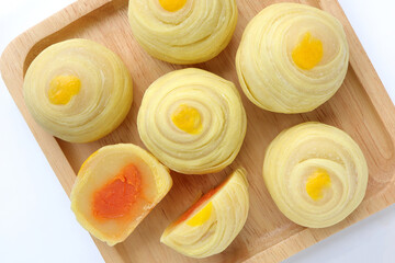 Chinese pastry or moon cake on wood plate. Chinese dessert Mini moon cake made from bean, flour and salted egg yolk.Top view