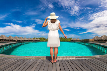 Woman standing on the wooden pier