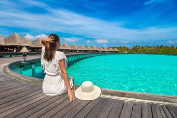 Woman sitting on the wooden pier