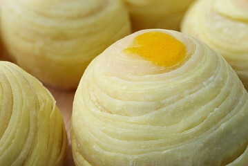 Chinese pastry or moon cake on wood plate. Chinese dessert Mini moon cake made from bean, flour and salted egg yolk.