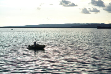 Man in a fishing boat silhouette