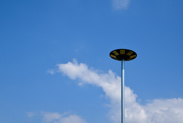 Mini lamp post for lighting at night powered by a solar panel on top of the lamp was installed near wooden walkway or pathway of a homestay, sustainable energy and environmental friend concept.