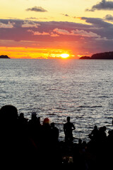 Rio de Janeiro, RJ, Brazil, 2022 - People in silhouette watch the sunset at Arpoador Rock, Ipanema...