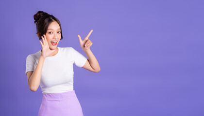 Portrait of a beautiful Asian woman posing on a purple background