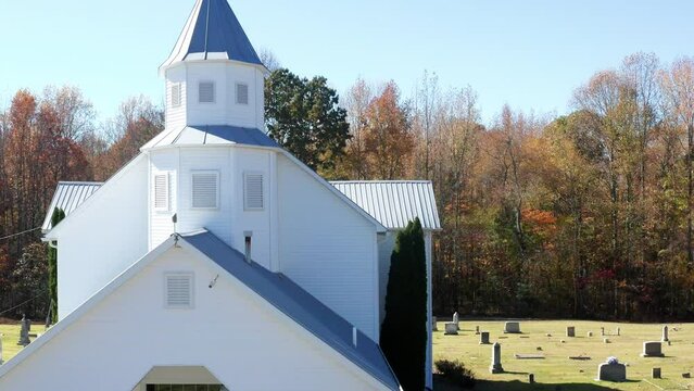 Southern American white country church in rural Tennessee fall season. Aerial view with autumn colors.