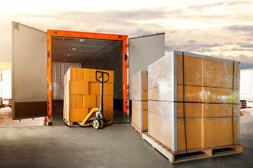 Package Boxes Stacked on Pallets Loading into Cargo Container. Delivery Shipping Trucks. Supply Chain Shipment Goods. Distribution Supplies Warehouse. Freight Truck Transport Logistics	