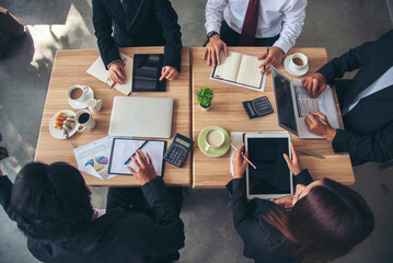 Top view business people meeting together at office desk in conference room. Team business meeting partnership planning brainstorming together. Team Collaborate group of partner company brainstorming